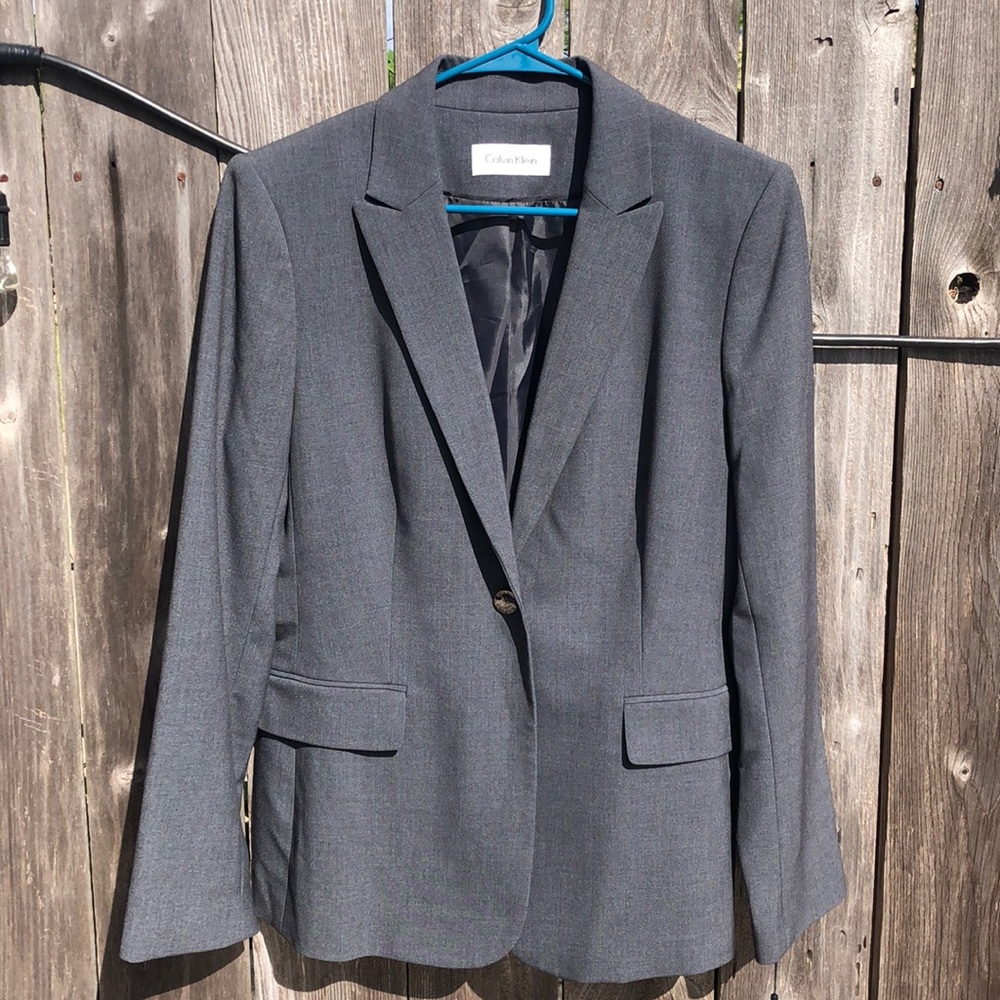 A grey Calvin Klein blazer in excellent condition. New
